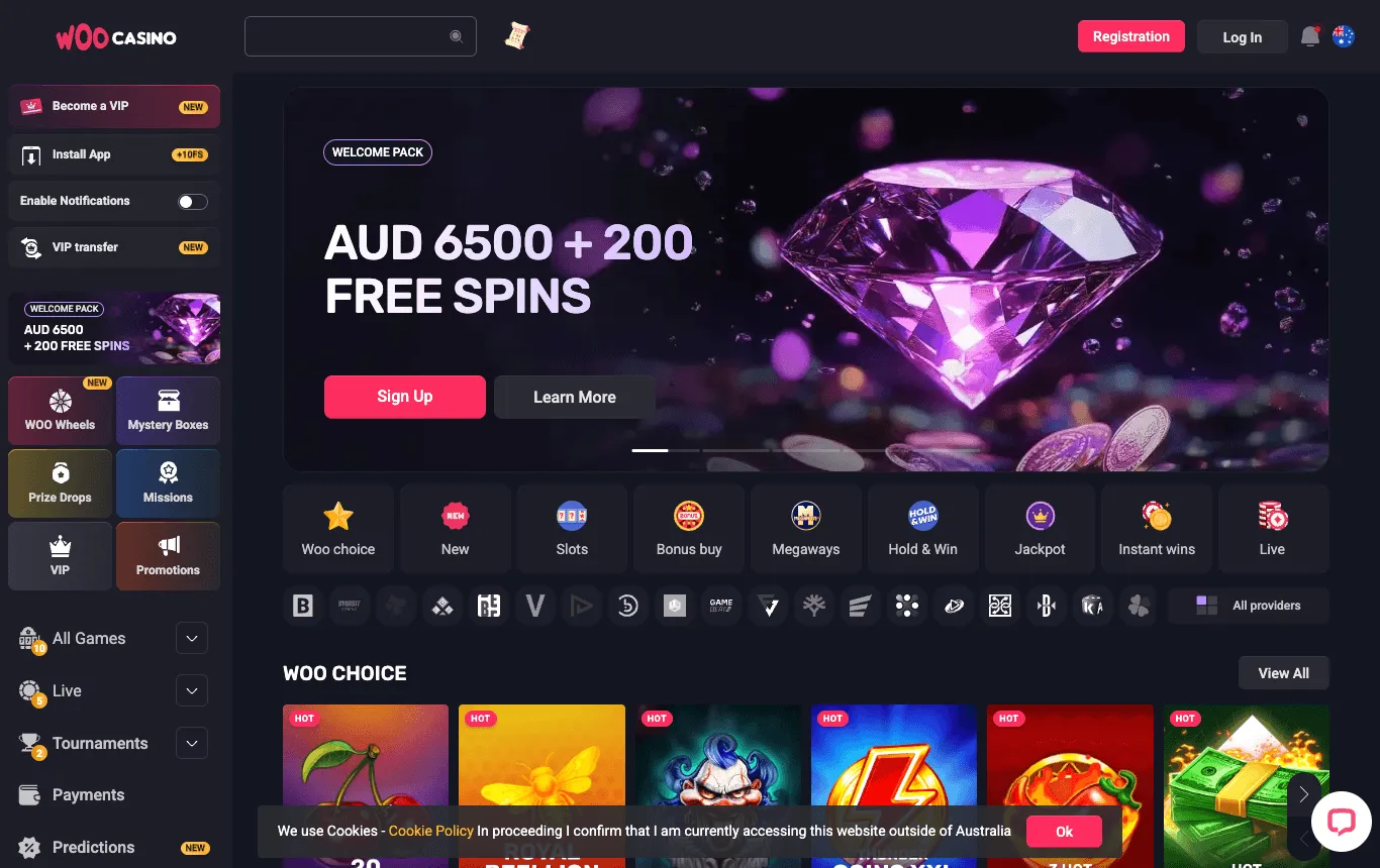 Woo Casino homepage: a welcome-pack banner in AUD with free spins and Sign Up and Learn More buttons; a left menu with VIP, app, Woo Wheels, Mystery Boxes, Prize Drops, Missions and Promotions; category tiles and provider logos; an Australian flag beside the Log In button; and a cookie bar with an Ok button and the text about accessing the website outside of Australia.